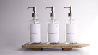 clear glass dispensers (shampoo, body wash, coniditioner)