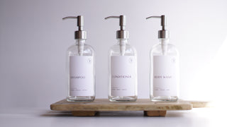 clear glass dispensers (shampoo, body wash, coniditioner)