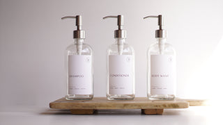 clear glass dispensers (shampoo, body wash, coniditioner)
