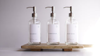 clear glass dispensers (shampoo, body wash, coniditioner)