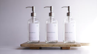 clear glass dispensers (shampoo, body wash, coniditioner)