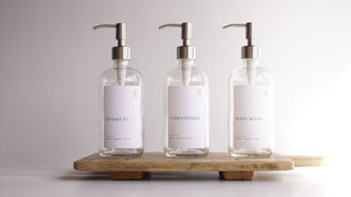 clear glass dispensers (shampoo, body wash, coniditioner)