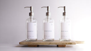 clear glass dispensers (shampoo, body wash, conditioner)