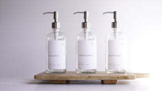 clear glass dispensers (shampoo, body wash, conditioner)