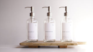 clear glass dispensers (shampoo, body wash, conditioner)