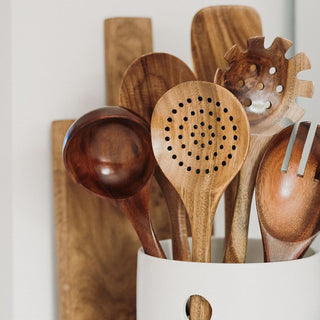 wooden kitchen utensil set with ceramic pot