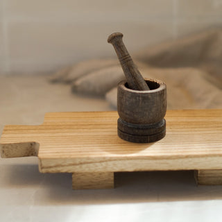 wooden paddle board tray with pestle and mortar

