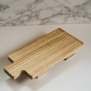 wooden tray with foot, paddle board style. serving board