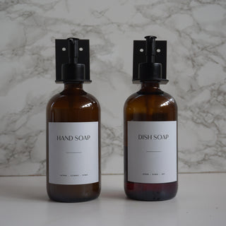Two brown bottles labeled 'Hand Soap' and 'Dish Soap' on a marble background